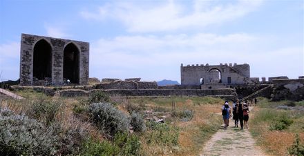 The Sea Gate seen from inside the castle, and on the left what has been left of an impressive public building.