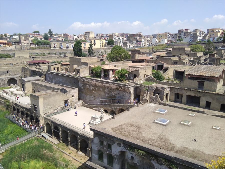 The Terrace of M.Nonius Balbus. The Sacred Area to its left and the Suburban Baths on its right.  Above of it is the House of the Deer and bellow it the boathouses with the sceletons.  At the background one can see the houses of the modern city of Ercolano.