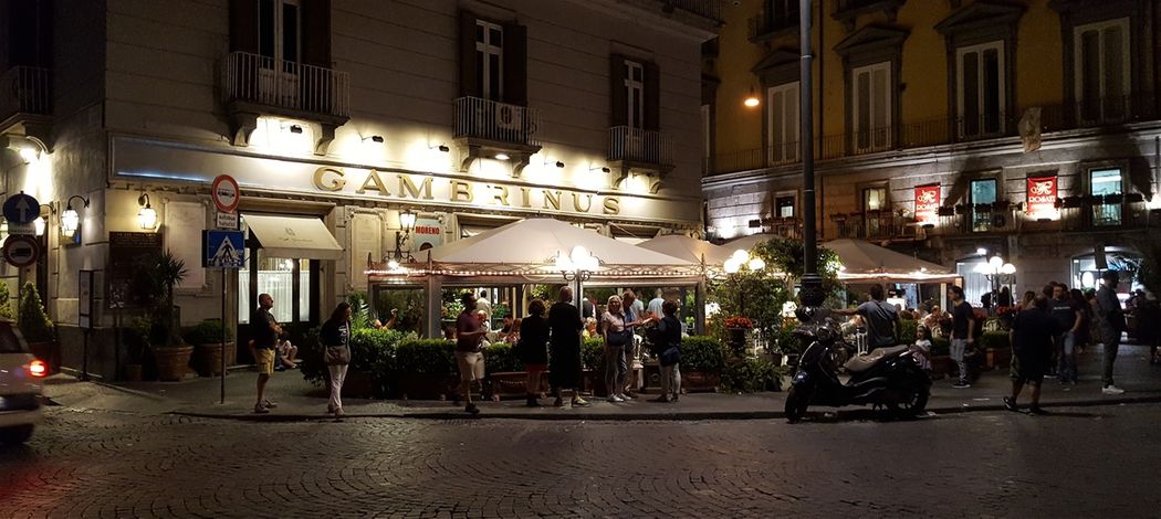 Gran Caffè Gambrinus in the evening.  The beginning of Via Chiaia is on the right of the picture.