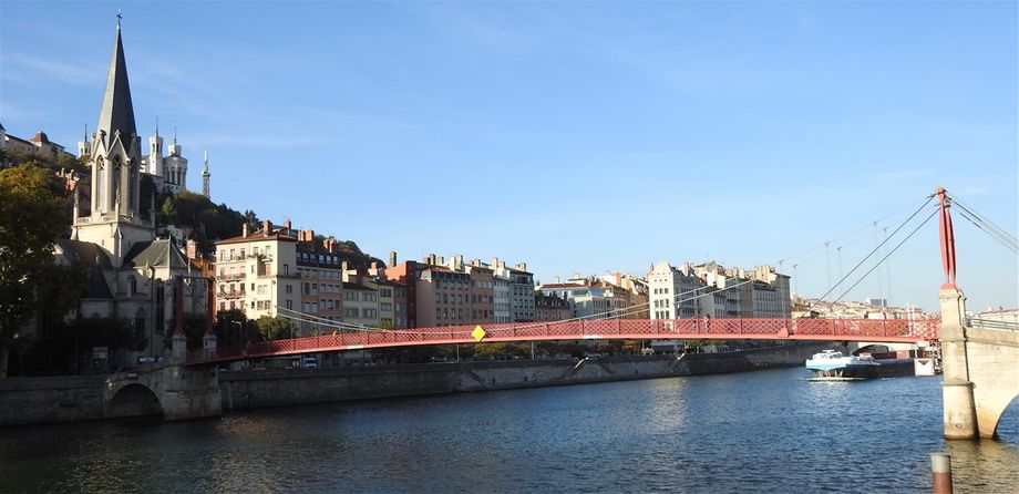 The red Passerelle St Georges and the Église Saint Georges in Vieux Lyon.