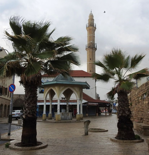 Mahmudiyya Mosque seen from Russlan street. The entrance to the mosque can be seen at the left side.  In the foreground stands a typical sebil kiosk-well.