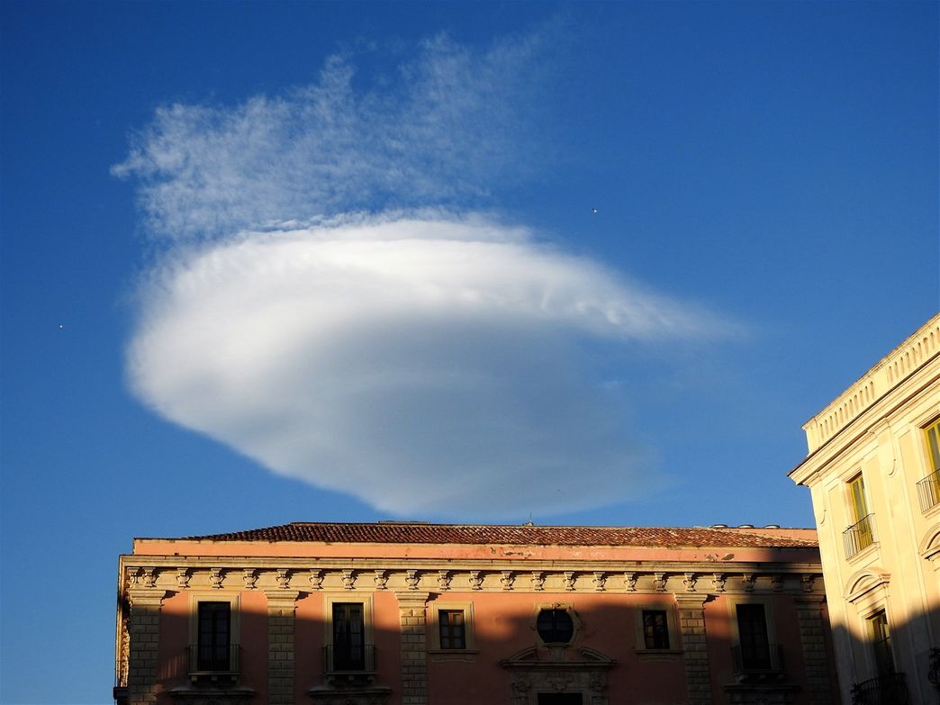 Smoke from Etna forming a lenticular cloud in the Catanese sky.