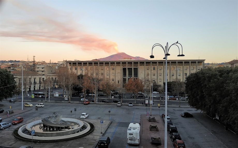 Piazza Verga photographed at dusk from my room at Hotel Mercure Catania Excelsior.  At the background, Etna smoking.