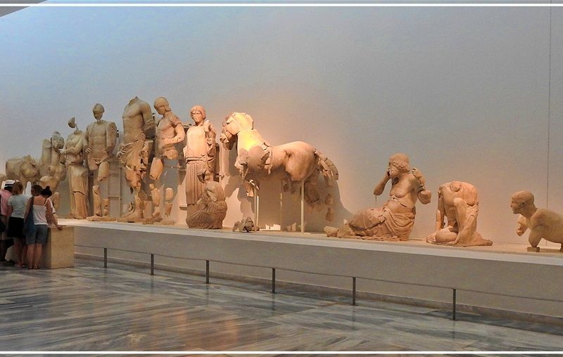 Terracottas Room. (left): The Group of Zeus and Ganymede is a multi-figure Late Archaic Greek terracotta statue group, depicting Zeus carrying the boy Ganymede off to Mount Olympus. It was created in the first quarter of the fifth century. The group was probably the acroterion of one of the treasuries at Olympia and is attributed to a Corinthian workshop.