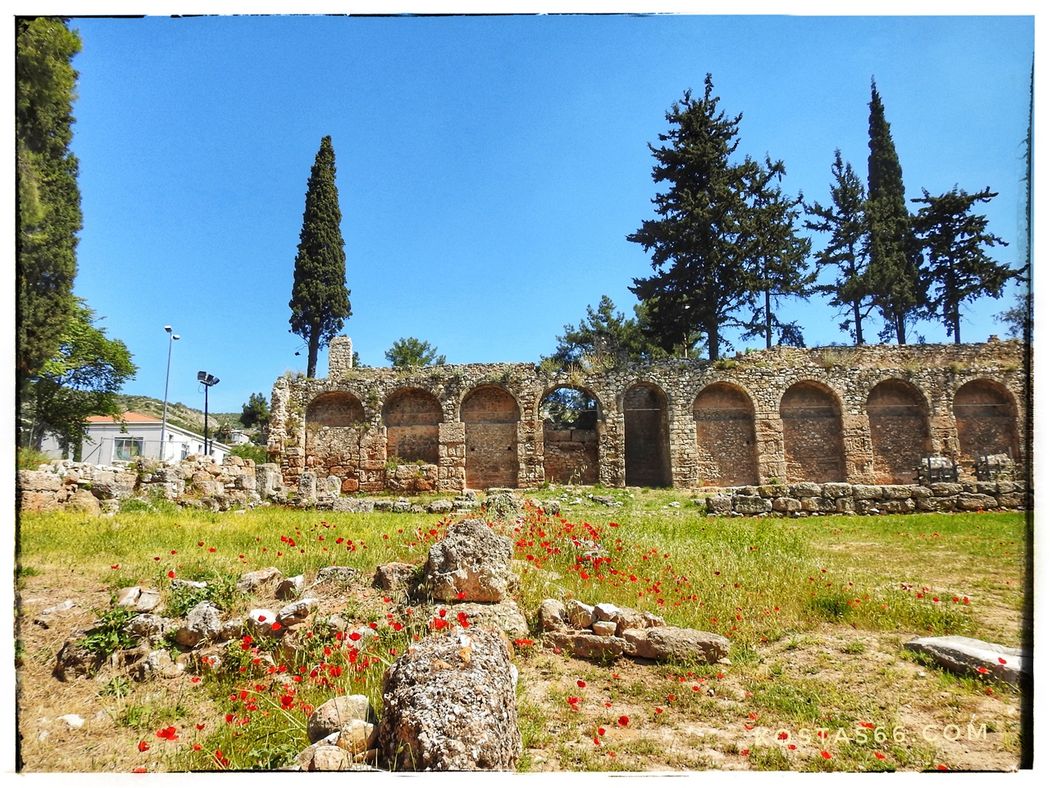 What has been left of the ancient sanctuary of Apollo Daphnaios in the foreground. The ruins of the north wall of the monastery can be seen at the background.