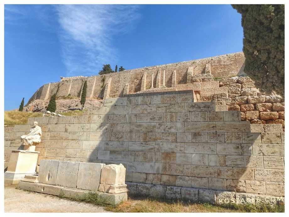 The eastern passage of the theater of Dionysus and a copy of the statue of poet Menandros.
