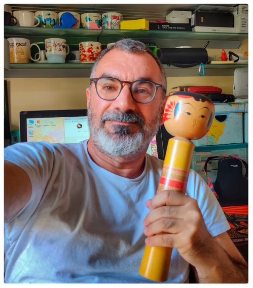 Me with a kokeshi, I brought back from my trip to Hokkaido.