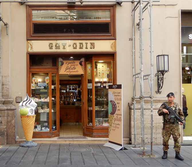 Heavily armed man outside famous chocolate shop Gay-Odin.