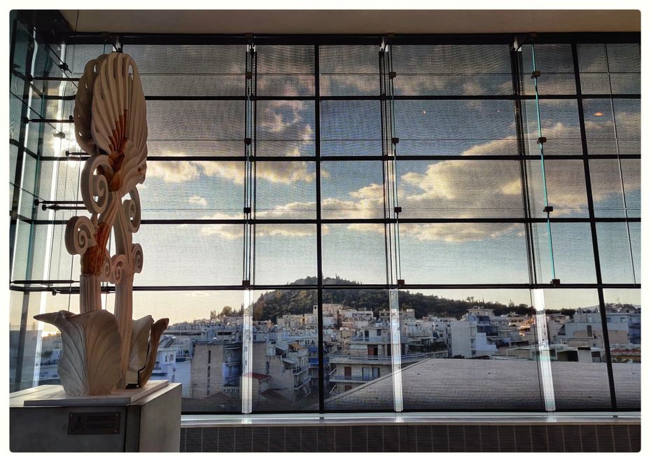 Roof ornamentation (finial - anthemion) of the Parthenon and the view of Filoppapos Hill.