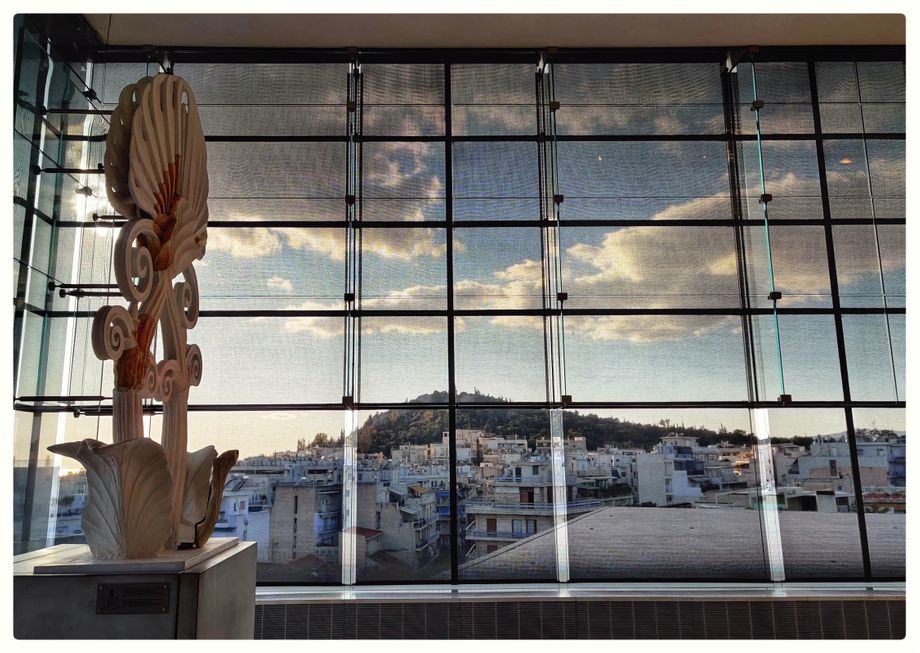 Roof ornamentation (finial - anthemion) of the Parthenon and the view of Filoppapos Hill.