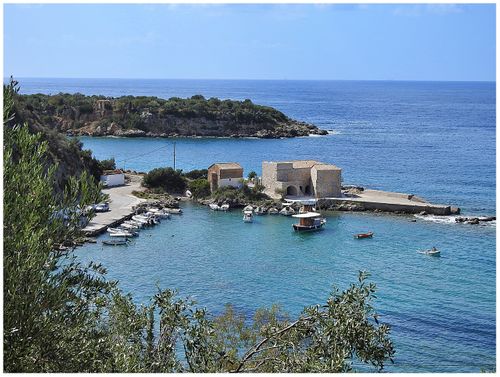 The Old Customhouse at Kardamyli. Next to the customhouse stands the chapel of Agios Ioannis and at the backround lies Meropi island with the chapel of Agios Nikolaos on it.
