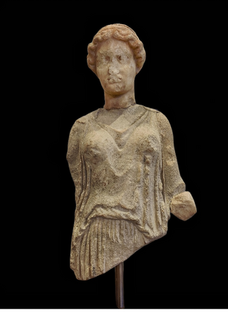 Marble female statuette, presumably Artemis. End of 5th century B.C. She is wearing a girded peplos forming an 'apoptygma' (overfold). Her hair is elaborately styled.