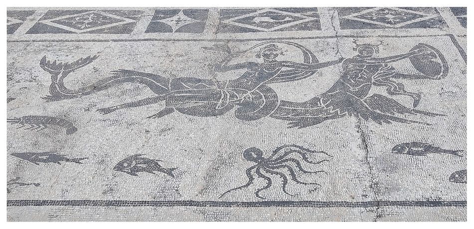 The Roman baths mosaic (detail). This scene depicts a woman, presumably a Nereid or a water spirit riding on the back of a Triton surrounded by lively sea creatures.