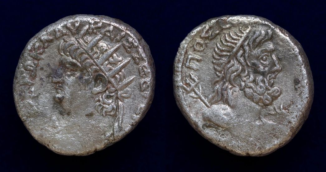 This coin commemorates the Isthmian Games in the Spring 66 or 67 AD, held at Korinthos (Isthmus of Corinth) in honor of Poseidon. Front: radiate bust of  Nero, wearing aegis. Back: ust of Poseidon Isthmios to right, wearing taenia, with slight drapery on his left  shoulder and with trident over his shoulder.